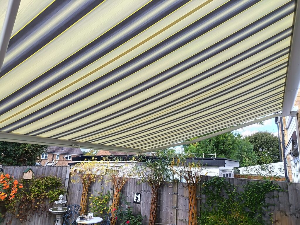 Underside of striped grey, cream and yellow Weinor Cassita II awning fabric in Headcorn