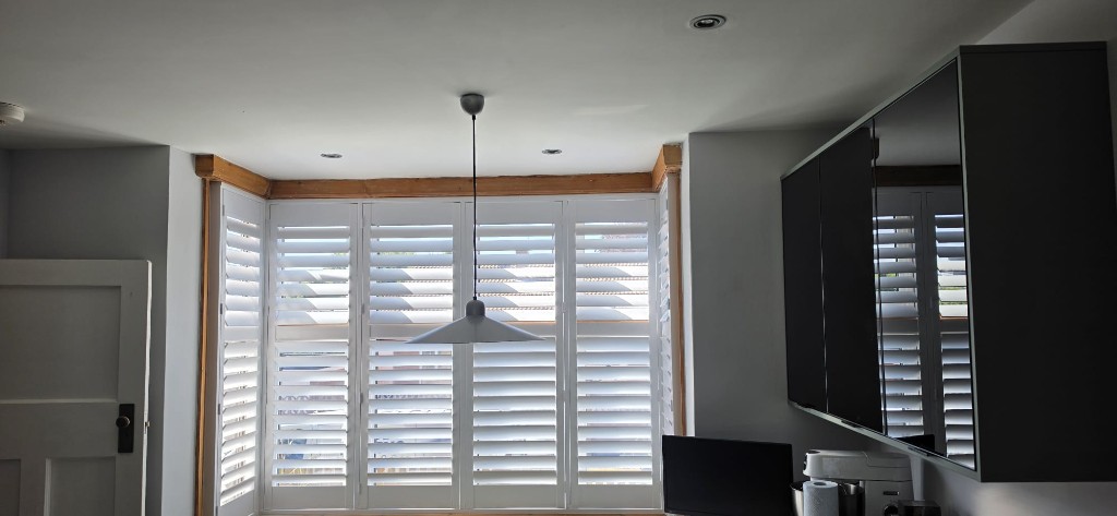 UK-manufactured hardwood plantation shutters with 89mm louvres fitted in a Maidstone, Kent kitchen by Abacus Blinds