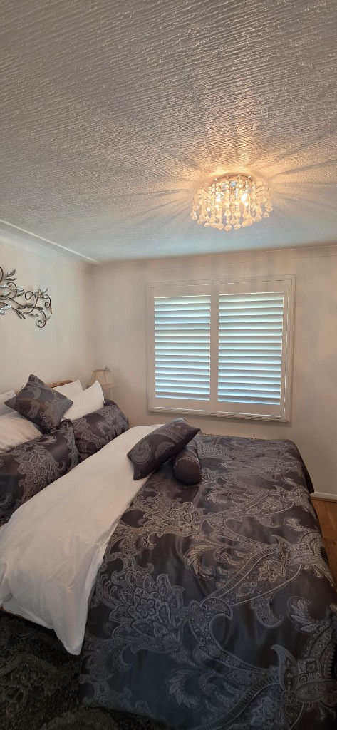 White shutters with 76mm louvres in a Margate caravan bedroom