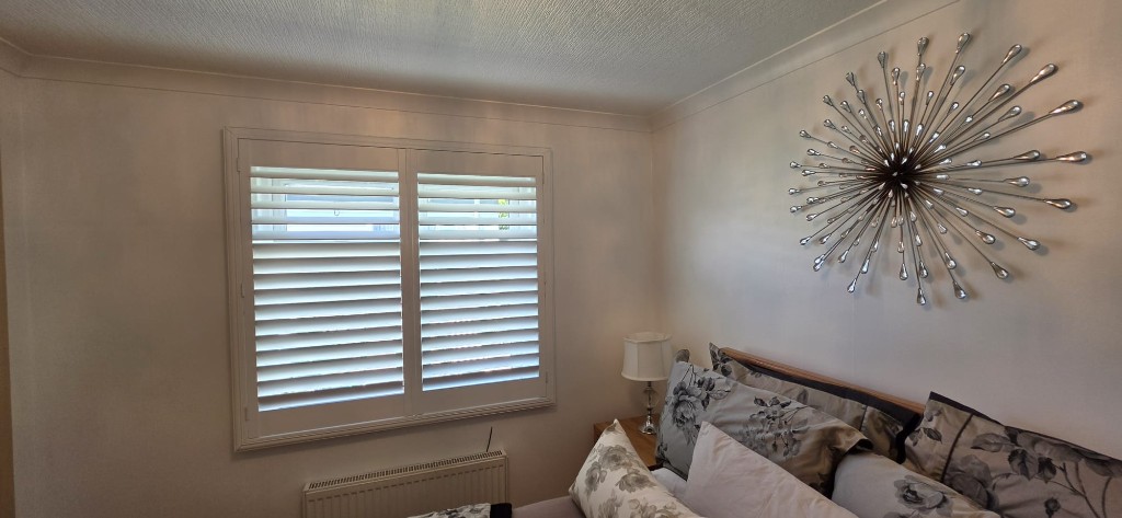 Corner bedroom with plantation shutters in a Margate static caravan