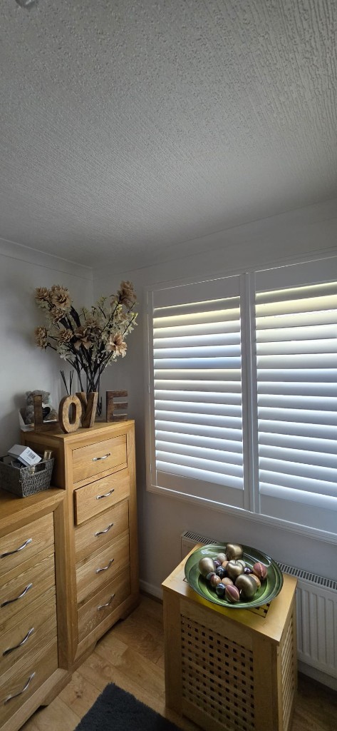 Pure white shutters with mid-rail in a Margate static caravan bedroom