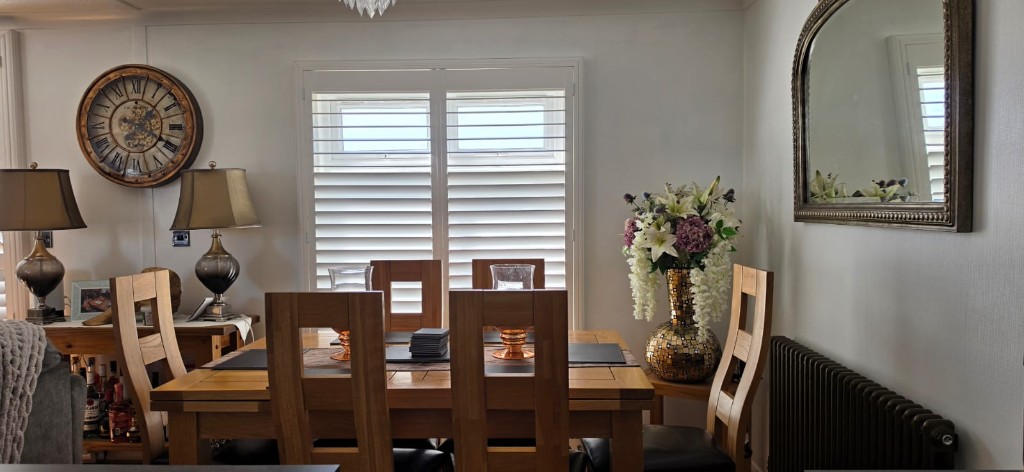 Pure white plantation shutters with 76mm louvres in a static caravan dining area, Margate Kent
