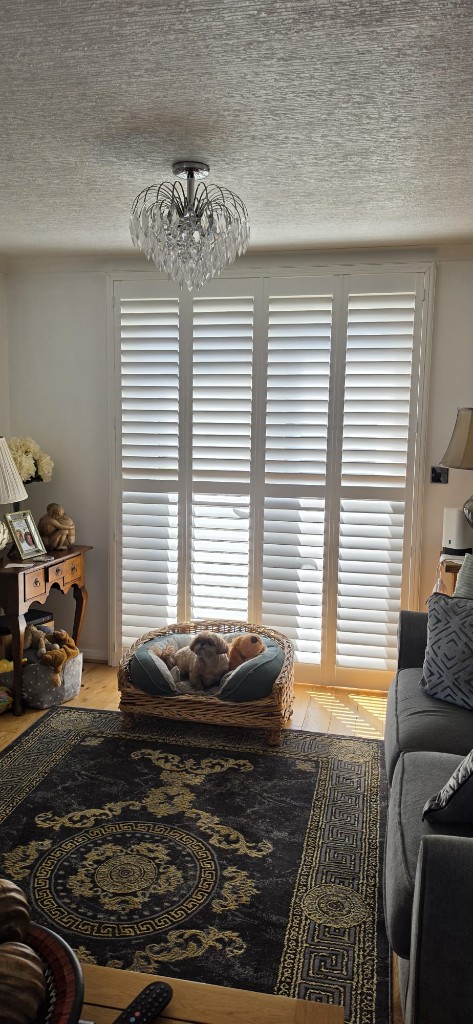 Four-panel pure white shutters with 76mm louvres in a Margate caravan living room