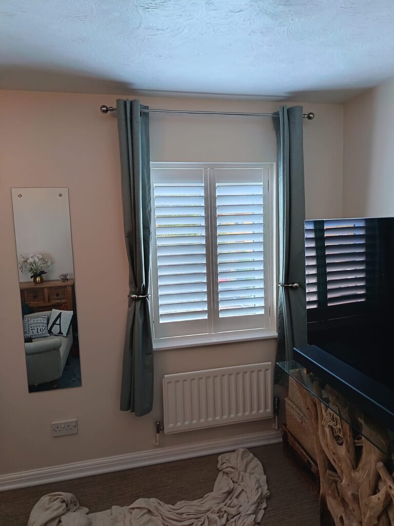 Two-panel Super White hardwood shutters in a second bedroom in Tovil, Maidstone