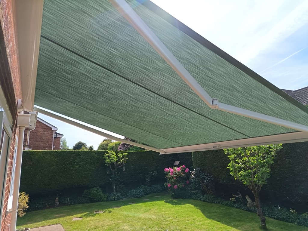Weinor Cassita II patio awning extended over a garden lawn in Loose, Kent