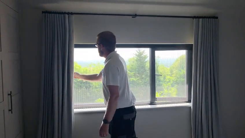Installer showing the pleated flyscreen mesh on a dual screen system in Westerham