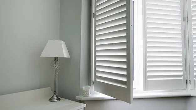 Classic plantation shutters installed in a Kent bay window