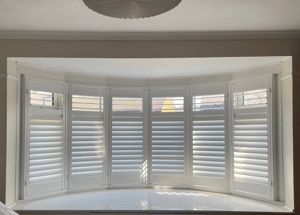 White plantation shutters in a Kent living room